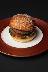 Classic burger on black background with copy space