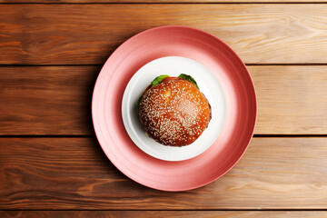 Fresh tasty burger on wooden table background