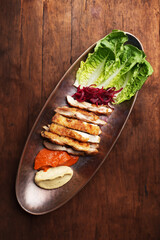 Fried chicken breast and mashed potato with tomato sauce