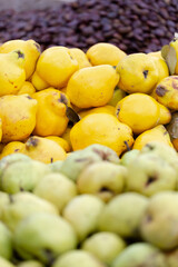 Fresh quince in bright yellow colour displayed for sale on local food market