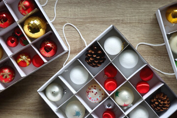 Boxes with various organized Christmas ornaments. Decorating or taking down the Christmas tree. Top view. - obrazy, fototapety, plakaty