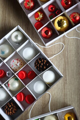Boxes with various organized Christmas ornaments. Decorating or taking down the Christmas tree. Top view.