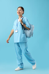 Asian medical intern on blue background