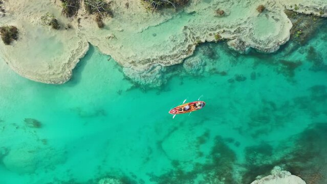 Kayaking in beautiful turquoise river. Drone view of Los Rapidos de Bacalar, Mexico