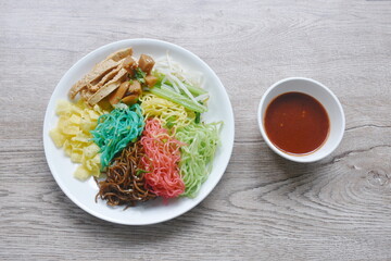 colorful noodles with sausage and fish line couple bean sprout on plate dressing spicy Korean sauce 