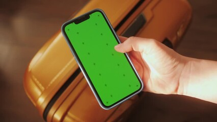 NEW YORK - April 5, 2018: Footage for animation, logo, final shot. Multiscreen footage, left part - hand woman use phone with green vertical screen on street at sunset, right part - hands woman