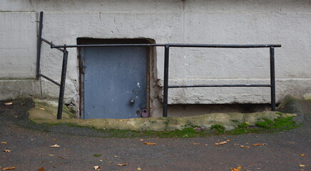 Padlocked metal entrance door to the basement