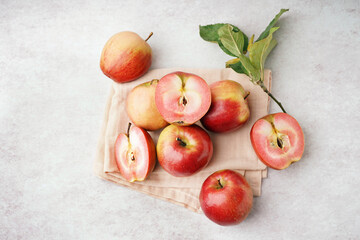 Sweet pink apples and leaves on white background