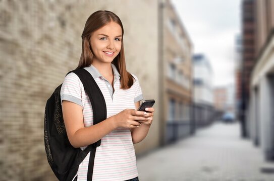 Happy young woman hold phone in the city street, AI generated image