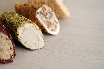 Rolls of turkish delight with many different flavors and fillings close up on table of vendors market bazaar with copy space