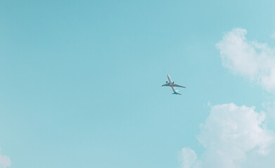 Airplane flies in clear blue sky