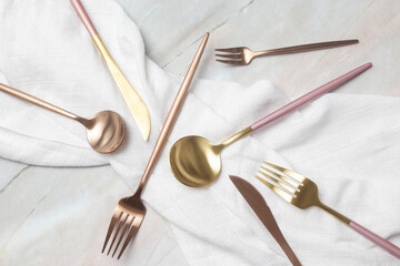 Creative shot of golden cutlery on marble table, Design concept. Modern kitchen. Scandinavian style tableware.	