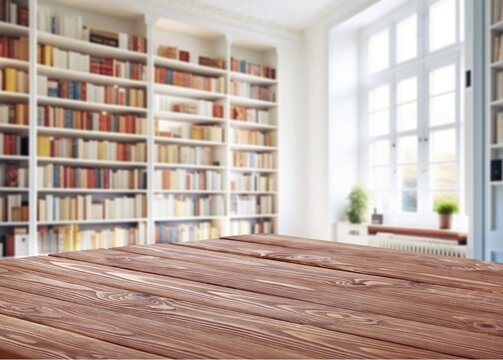 Wooden empty desk on library with bookshelf background, AI generated image