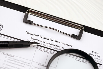 I-140 Immigrant petition for alien workers blank form on A4 tablet lies on office table with pen...