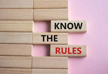 Know the rules symbol. Wooden blocks with words Know the rules. Beautiful pink background. Business...