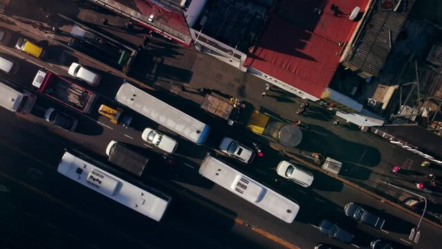 City road traffic, busy urban street with trucks, auto cars and buses.