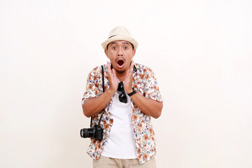 Shocked asian man traveler standing while surprised with open mouth. Isolated on white background