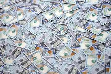 Very big amount of US hundred dollar bills close up. Huge quantity of united states currency notes on flat table