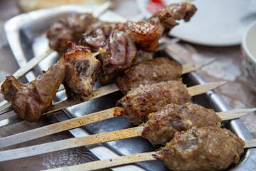 A kind of traditional dish where iron rods are inserted into the middle of the meat and it is...