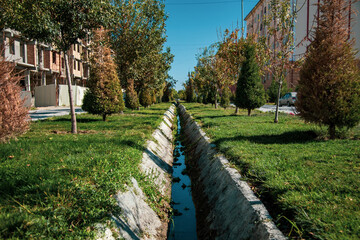 It is divided into two sides with a canal in the middle and beautiful greenery on both sides of it