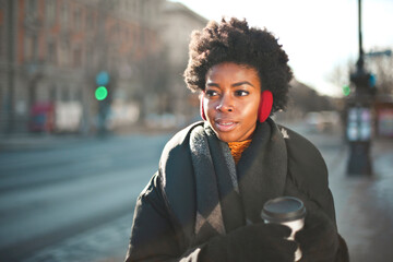 young woman in the street with a cup of tea - obrazy, fototapety, plakaty