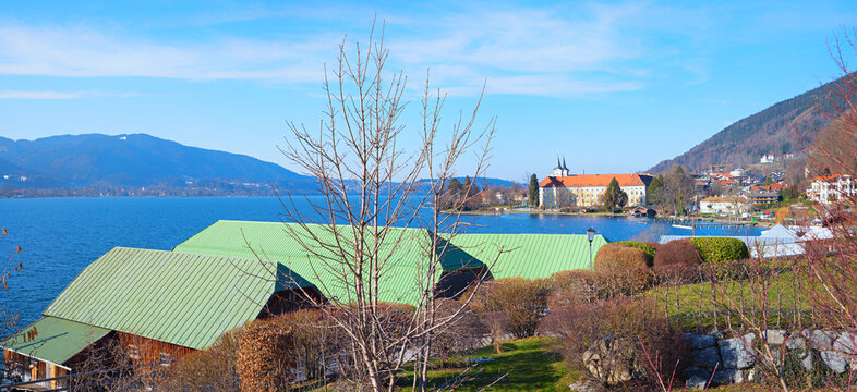 view to Tegernsee brewery and castle, landscape upper bavaria. boathouses at the shore