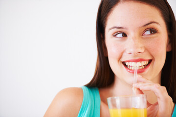 Happy, drinking and face of woman with juice for nutrition, wellness and hydration in studio. Beverage, smile and thirsty person with fruit blend for vitamins, detox and diet on white background