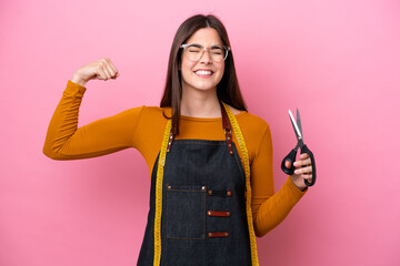 Young Brazilian seamstress woman isolated on pink background doing strong gesture