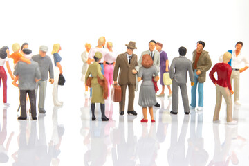 miniature people. group of different people communicate with each other on a white background....