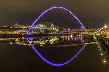 Fototapeta na wymiar Millenium bridge lit up in memory of the Queen