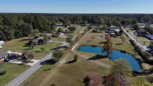 An aerial view of a small North Carolina residential neighborhood with small pond.  	