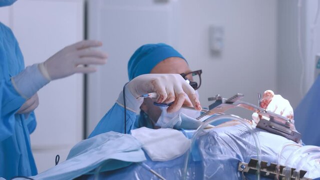 A professional surgeon performs heart surgery in a medical facility together with a well-coordinated team of doctors