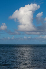 Obraz premium Beautiful white clouds above the Pacific Ocean in Kauai, Hawaii, United States. 