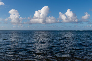 Fototapeta premium Beautiful white clouds above the Pacific Ocean in Kauai, Hawaii, United States. 