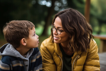 Obraz premium Affectionate moment between smiling mother and son at home, showcasing a warm, loving family dynamic.