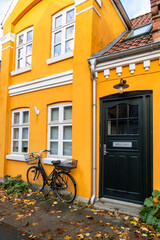Fototapeta na wymiar Odense, Denmark A yellow and orange residential building on Odinsgade in the downtown.