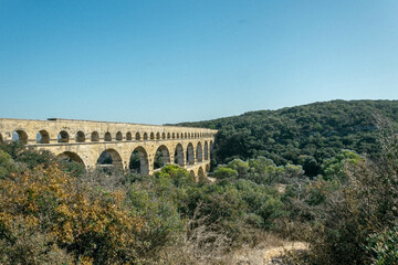 pont du gard aqueduct surrounded by nature in a landscape