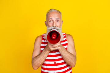 Photo portrait of screaming bossy elderly local beach products seller megaphone in striped overall...