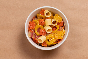 Various non-expanded snacks in a bowl on a brown background