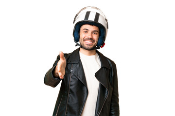 Young caucasian man with a motorcycle helmet over isolated chroma key background shaking hands for closing a good deal
