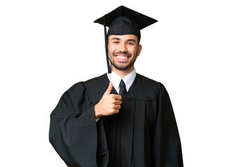 Young university graduate man over isolated chroma key background giving a thumbs up gesture