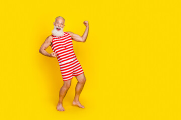 Full length photo of overjoyed positive person raise fists shout yeah hooray empty space isolated on yellow color background