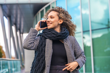 Beauty woman wearing elegant clothes talking to the mobile outdoors