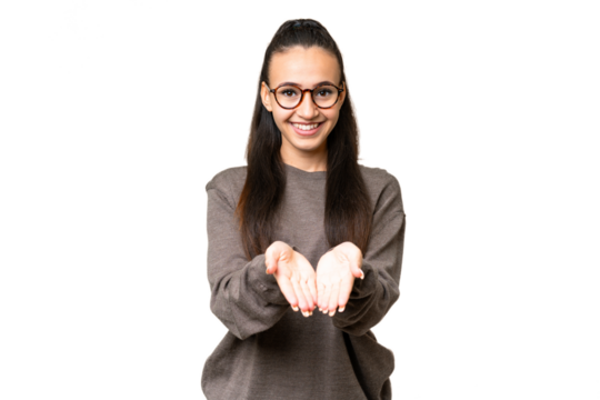 Young Arabian woman over isolated chroma key background holding copyspace imaginary on the palm to insert an ad