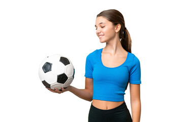 Teenager caucasian girl playing football over isolated background with happy expression