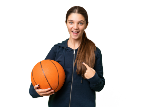 Teenager caucasian girl playing basketball over isolated background with surprise facial expression