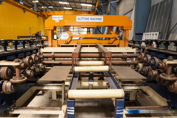 A wide view of the slitting machine inside the industrial unit or factory - obrazy, fototapety, plakaty