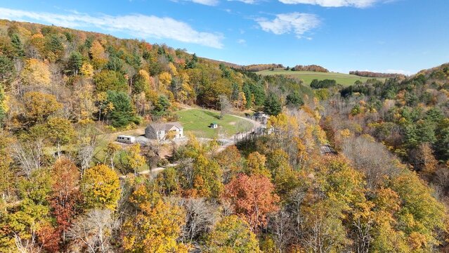 Green rolling hills with farmland and houses life in a small town in America Wellsboro, PA