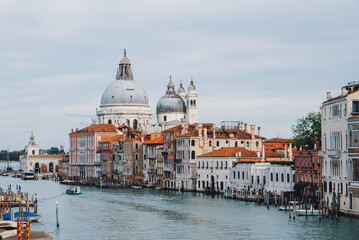 Fototapeta na wymiar Famous view of Venice Grand Canal with Saint Mary of Health dome on sunny day from Ponte dell'Accademia bridge. Italian travel destination and landmark, tourist attraction.