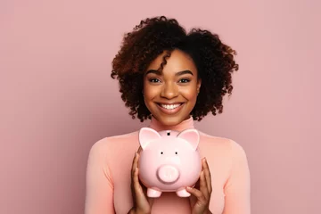 Fotobehang Happy African American woman holding piggy bank, looking at camera. © AI_images